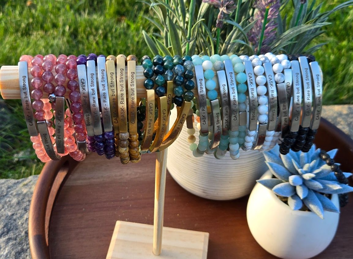 Bracelets of Hope displayed on a wooden stand
